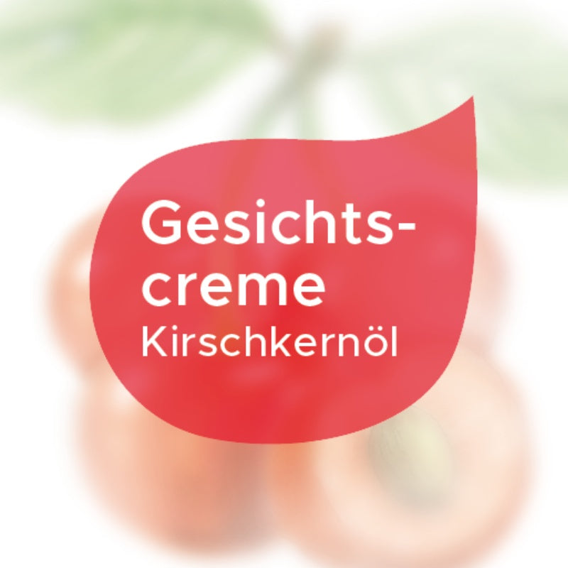 Etikett Gesichtscreme mit Kirschkernöl in einem roten Tropfen auf weißem Hintergrund